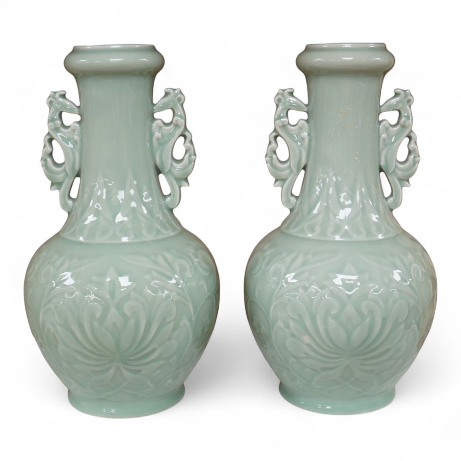 A pair of Chinese celadon glazed vases, decorated in low relief, 32cm high